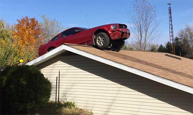 Red Ford Mustang Lands On House Roof. No, We’re Not Joking.