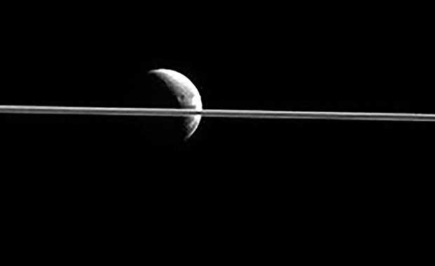 NASA Releases Stunning Photos of Saturn ‘Cutting’ Its Moon in Half