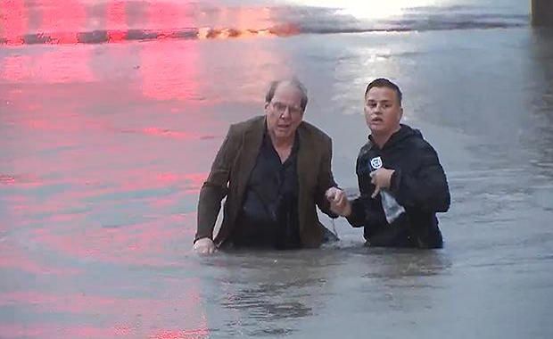 Watch This Slightly Annoyed Reporter Save a Man From His Sinking Car During Live Report
