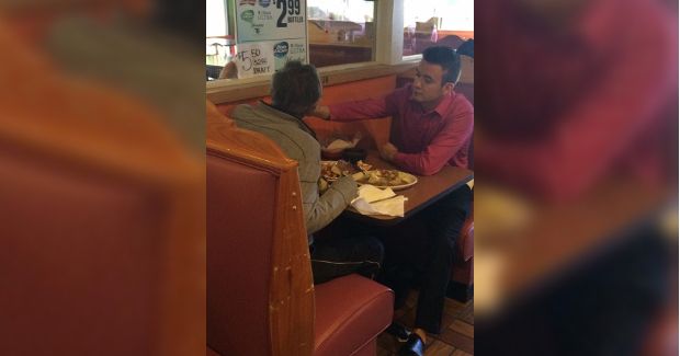 Patient, Caring Waiter Sits Down to Feed Customer With No Hands