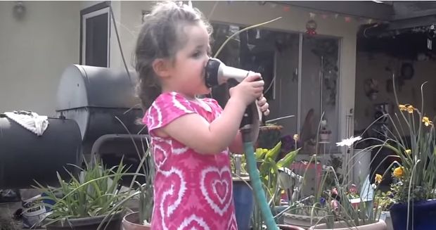 Little Girl Gets Unexpected Lesson About Water Pressure After Trying to Drink From Hose