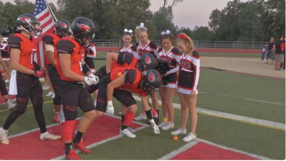 High School Football Team Surprise Cheerleader Battling Leukemia With Orange Roses