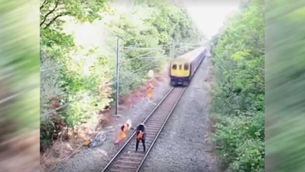 Watch as Rail Worker Saves a Drunk Cyclist From Incoming Train