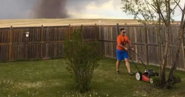Man Ignores Impending Storm and Continues to Mow His Lawn in Now Viral Photo