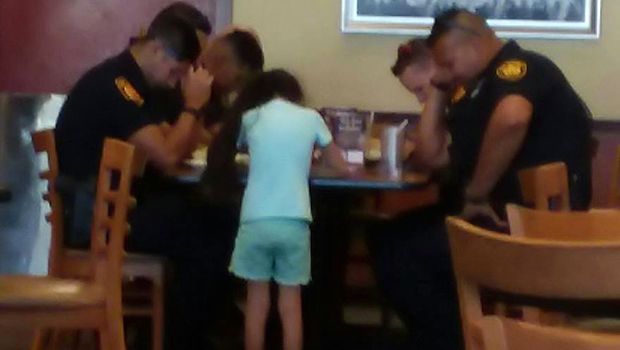 Young Girl Prays With Police Officers in Viral Photo